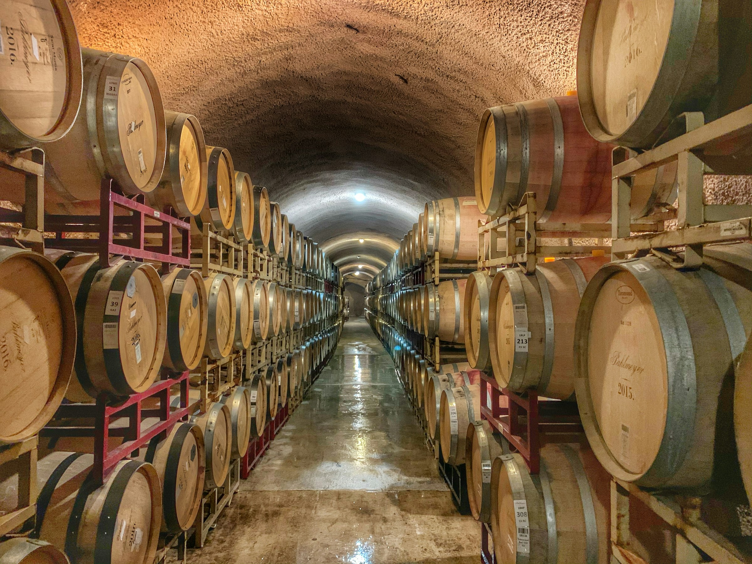 Photo of wine barrels in an underground cellar, by Jim Harris from Unsplash