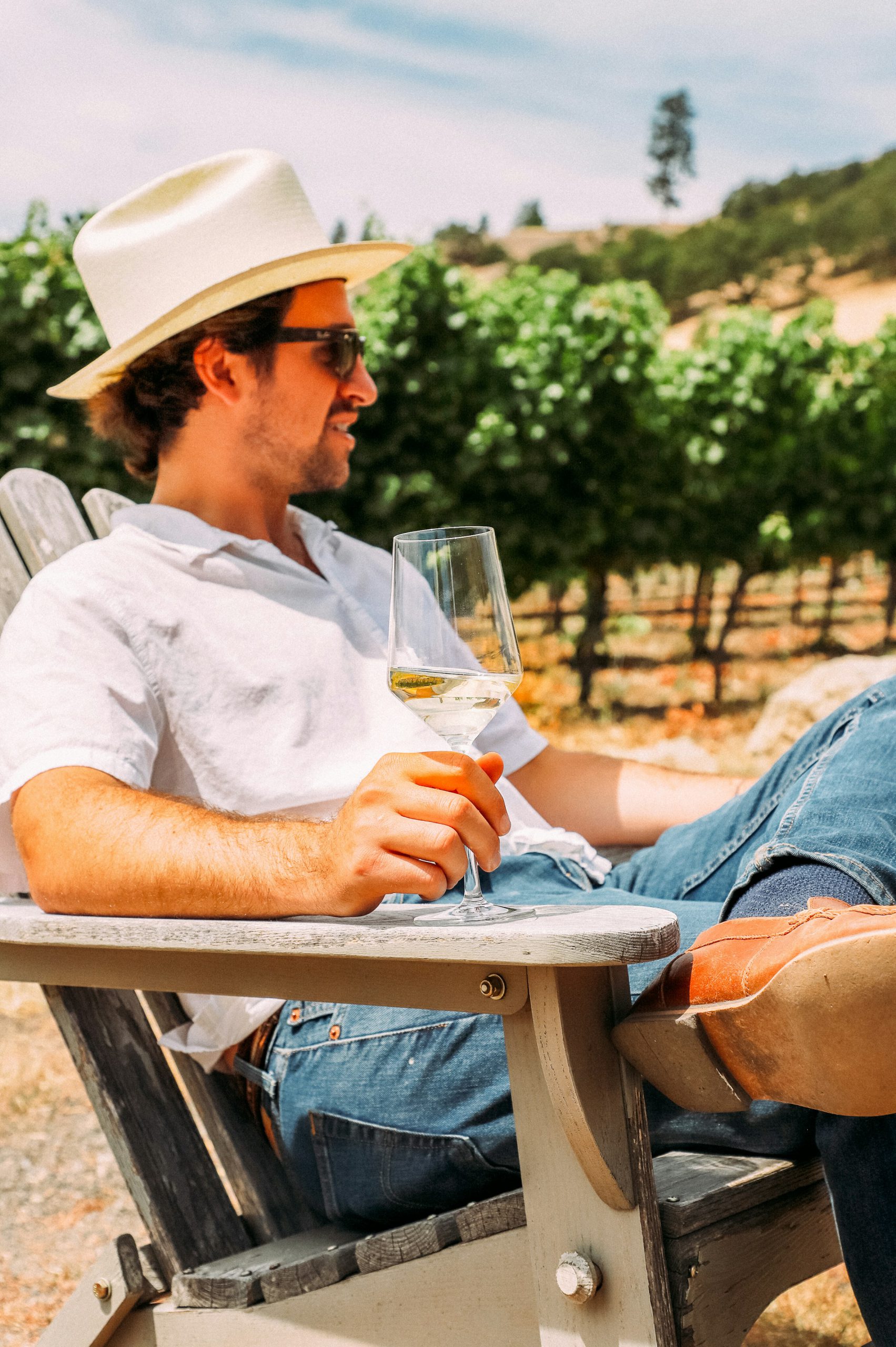 Photo of a man drinking wine outdoors, by Kelsey Curtis from Unsplash