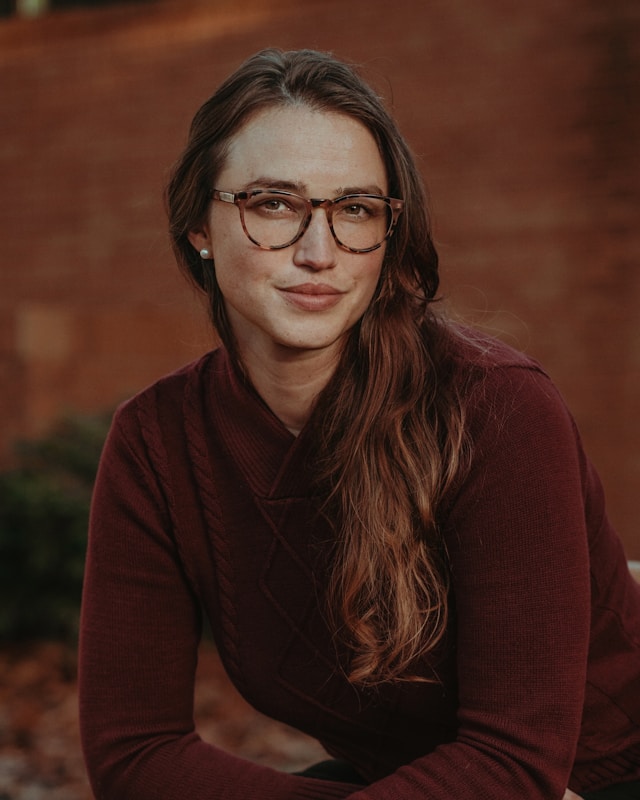 Photo of a woman wearing glasses, by Lance Reis from Unsplash